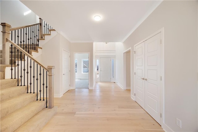 7004 NE 102nd Ct, Kansas City, MO 64156 - entrance foyer with wood finished floors, ornamental molding, and stairs