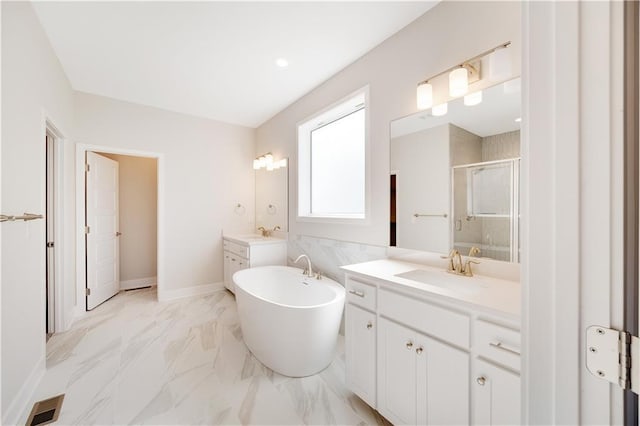 7004 NE 102nd Ct, Kansas City, MO 64156 - full bath featuring two vanities, a stall shower, a freestanding bath, and marble finish flooring