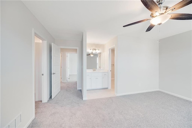 7004 NE 102nd Ct, Kansas City, MO 64156 - unfurnished bedroom with light colored carpet, connected bathroom, and a ceiling fan