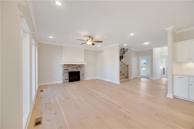 7004 NE 102nd Ct, Kansas City, MO 64156 - unfurnished living room featuring stairs, a ceiling fan, recessed lighting, light wood-type flooring, and ornamental molding