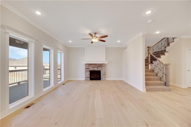7004 NE 102nd Ct, Kansas City, MO 64156 - unfurnished living room featuring light wood finished floors, ceiling fan, ornamental molding, stairway, and recessed lighting