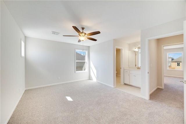 7004 NE 102nd Ct, Kansas City, MO 64156 - empty room featuring a ceiling fan, light carpet, and healthy amount of natural light