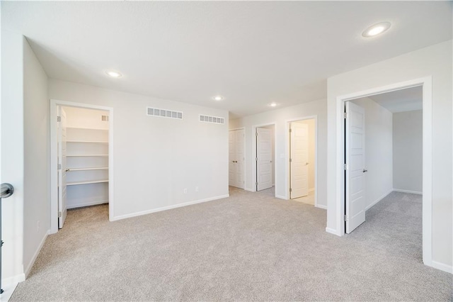7004 NE 102nd Ct, Kansas City, MO 64156 - unfurnished bedroom with carpet, a spacious closet, and recessed lighting