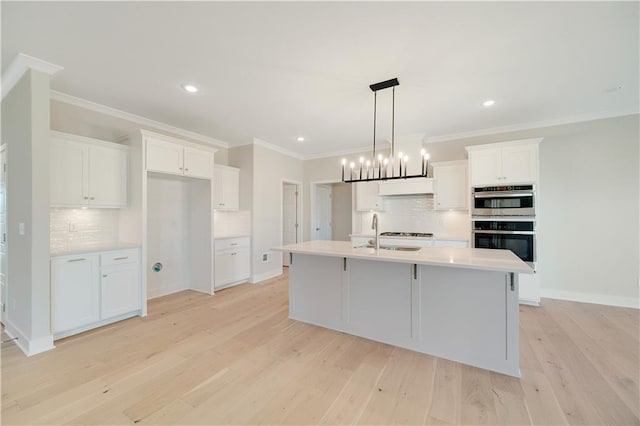 7004 NE 102nd Ct, Kansas City, MO 64156 - kitchen featuring tasteful backsplash, stainless steel double oven, white cabinetry, light wood finished floors, and ornamental molding