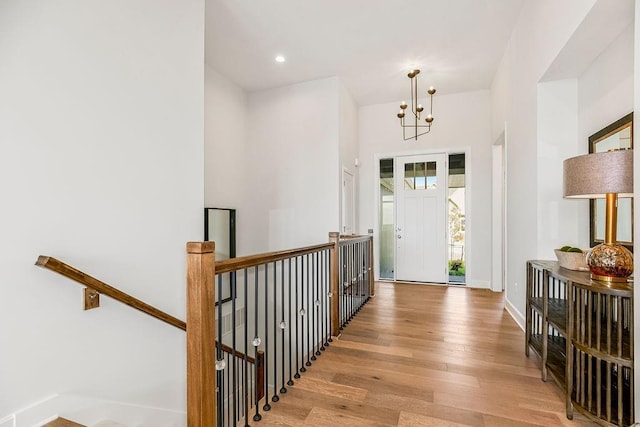 foyer entrance featuring a chandelier and light wood-type flooring