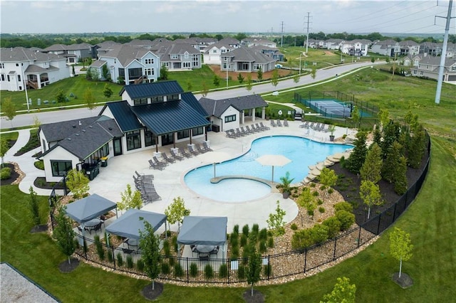 view of pool with a patio and a yard