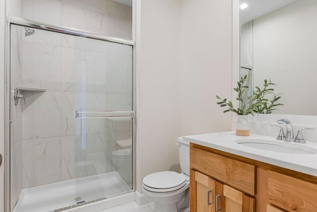 bathroom featuring walk in shower, vanity, and toilet