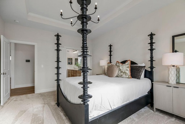 carpeted bedroom featuring an inviting chandelier, a tray ceiling, and ornamental molding