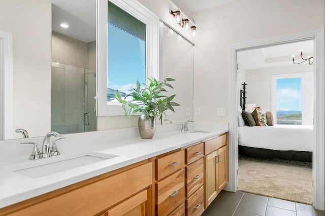 bathroom featuring vanity, a shower with shower door, and tile patterned flooring