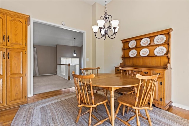 dining room featuring light hardwood / wood-style flooring and a notable chandelier