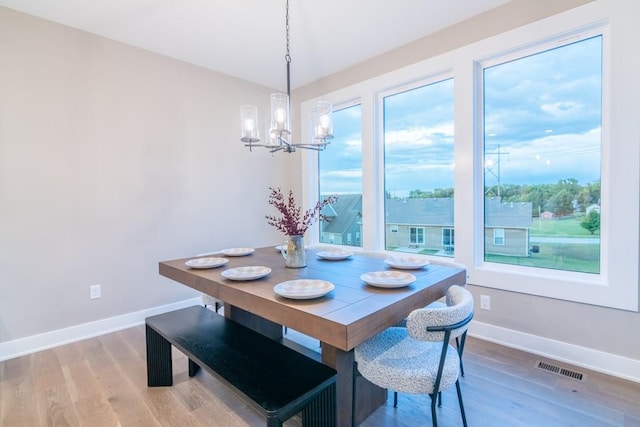 dining room with an inviting chandelier and hardwood / wood-style floors