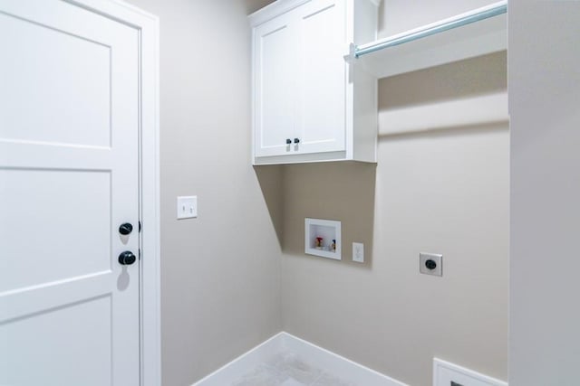 washroom featuring hookup for a washing machine, cabinets, light tile patterned floors, and electric dryer hookup