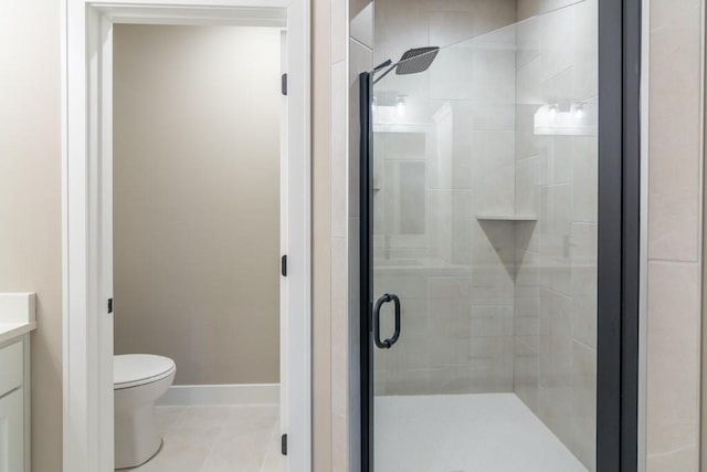 bathroom featuring vanity, tile patterned flooring, toilet, and an enclosed shower