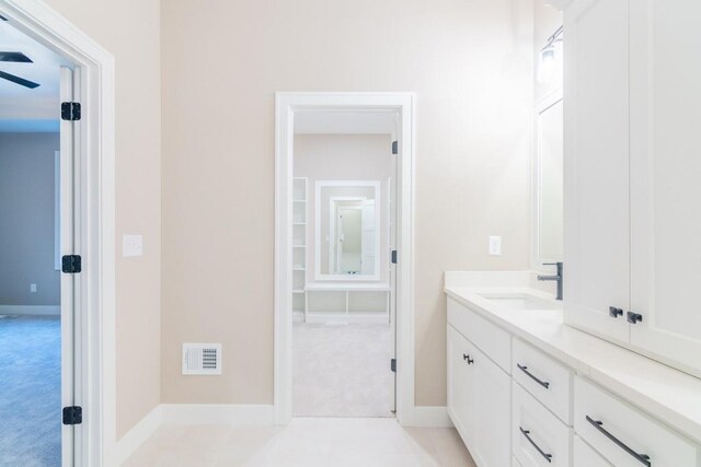 bathroom featuring ceiling fan and vanity