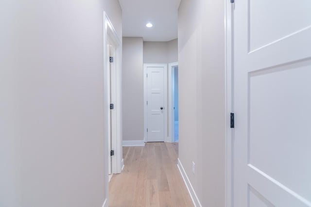 hallway with light hardwood / wood-style floors