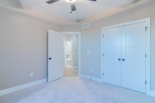 unfurnished bedroom with a closet, ceiling fan, and light carpet