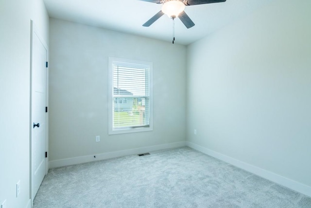 empty room featuring light carpet and ceiling fan