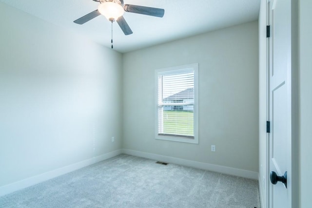 empty room featuring light carpet and ceiling fan