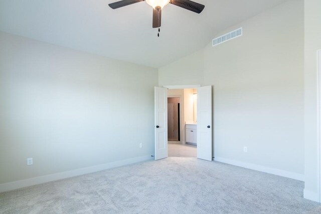 carpeted empty room featuring high vaulted ceiling and ceiling fan