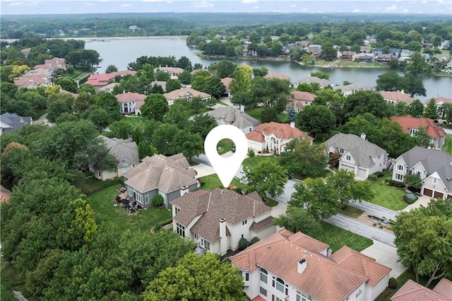 birds eye view of property with a water view and a residential view