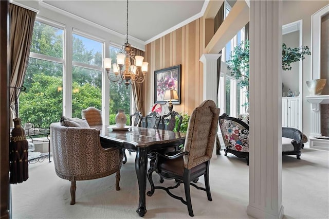 dining area featuring ornamental molding, light carpet, wallpapered walls, and an inviting chandelier