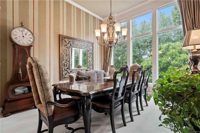 dining space with wallpapered walls, plenty of natural light, ornamental molding, and a chandelier