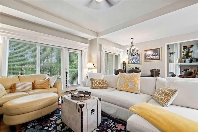 living room featuring a fireplace and a chandelier