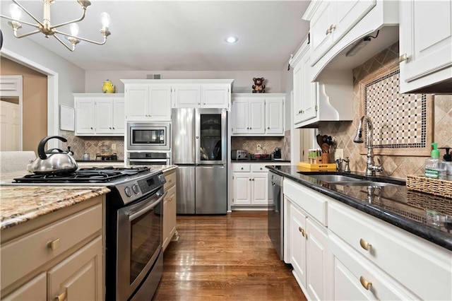 kitchen featuring white cabinets, stainless steel appliances, and a sink