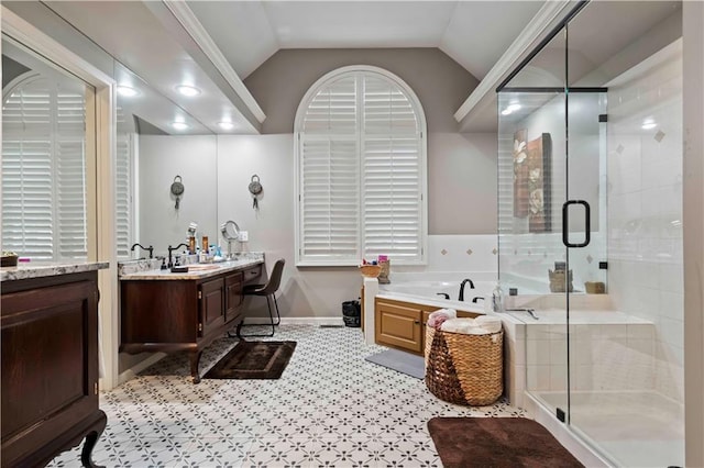 bathroom with vaulted ceiling, vanity, a shower stall, and a bath