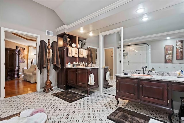 full bathroom with crown molding, lofted ceiling, visible vents, a sink, and a shower stall