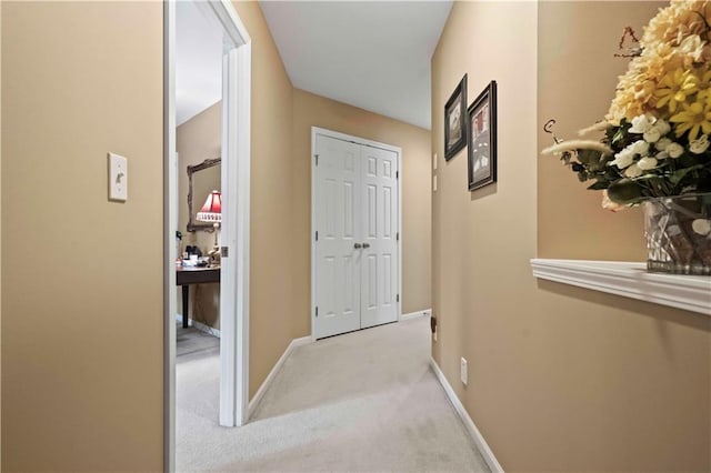 corridor with carpet floors and baseboards