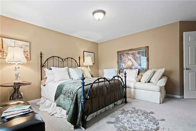 bedroom featuring carpet and baseboards