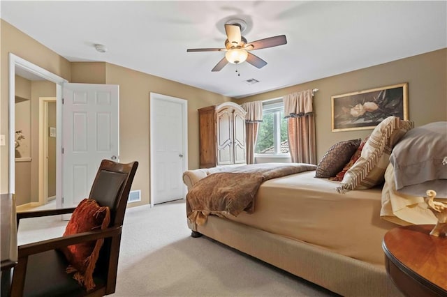 bedroom with ceiling fan, carpet floors, and visible vents