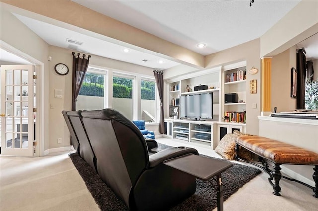 interior space with carpet floors, built in shelves, recessed lighting, visible vents, and baseboards