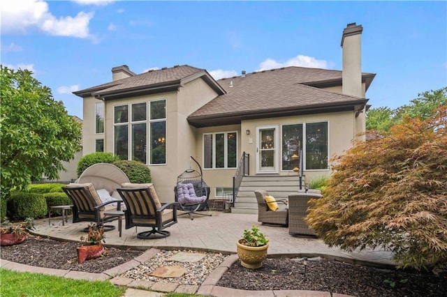 back of house with a patio, a chimney, and stucco siding