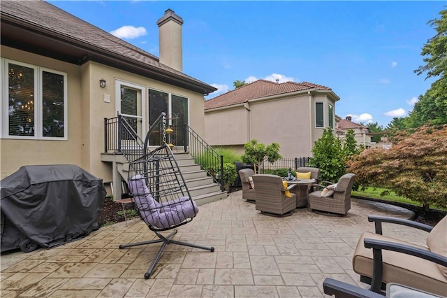 view of patio / terrace with outdoor dining area, a grill, and fence