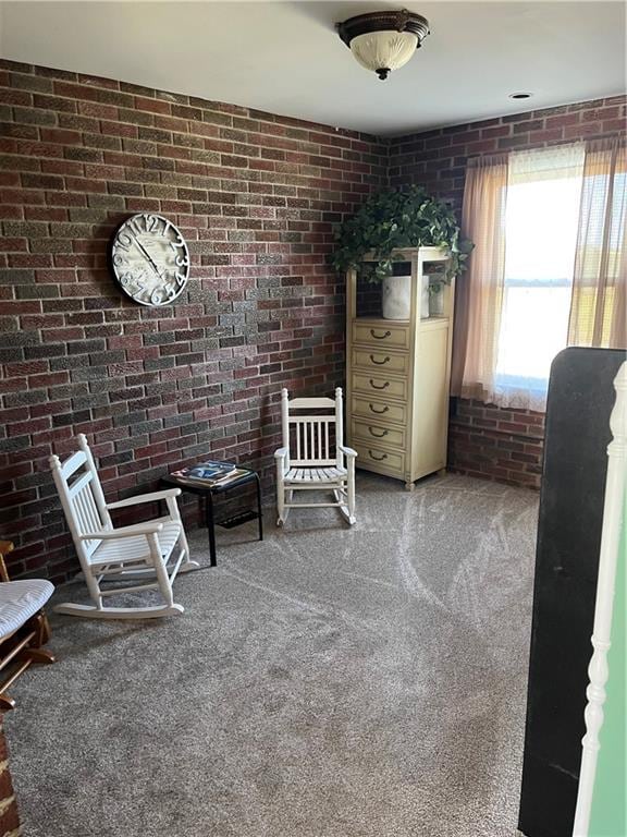 unfurnished room featuring carpet floors and brick wall