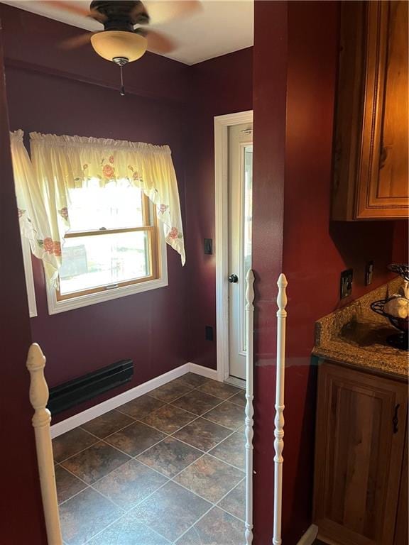 interior space featuring tile patterned floors and ceiling fan