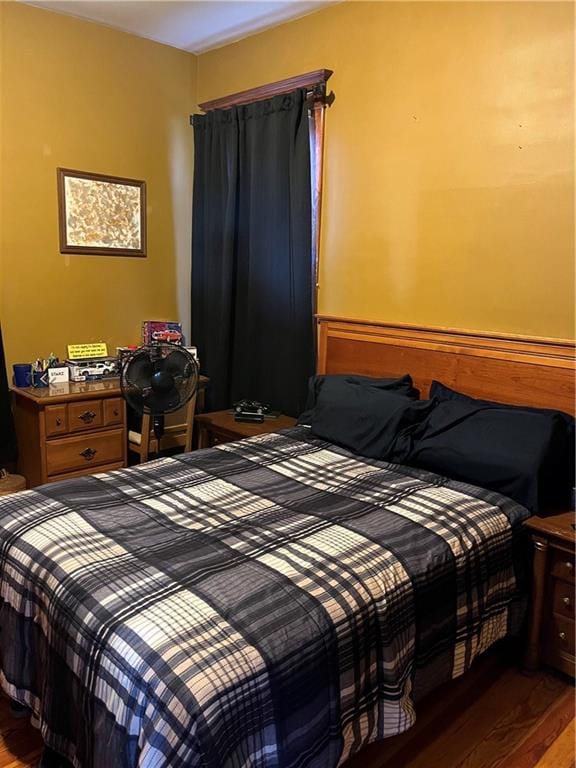 bedroom with dark wood-type flooring