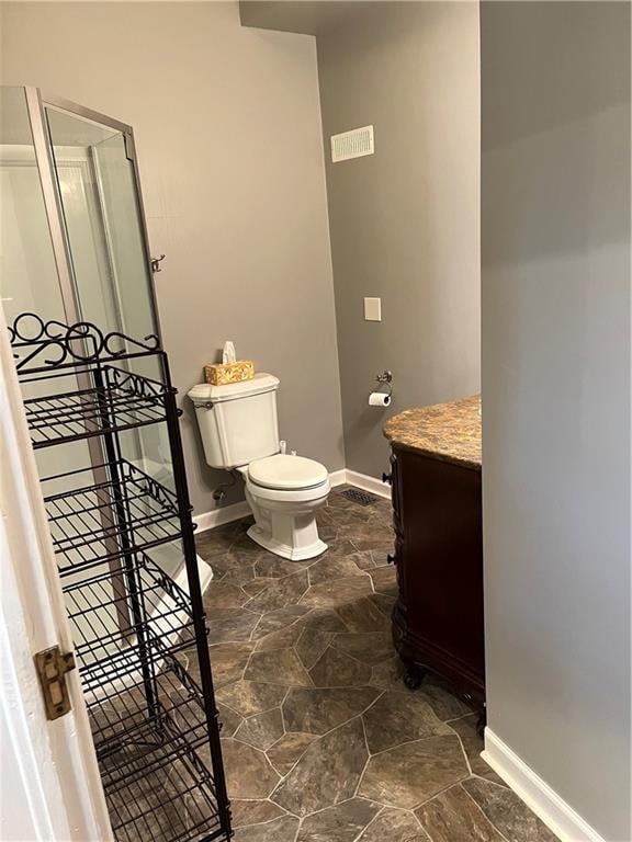 bathroom with vanity, tile patterned flooring, and toilet