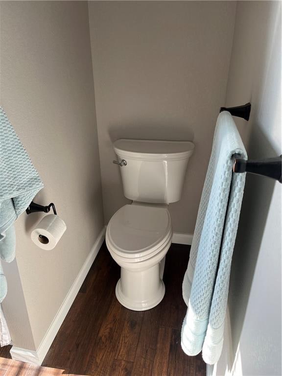 bathroom with hardwood / wood-style flooring and toilet