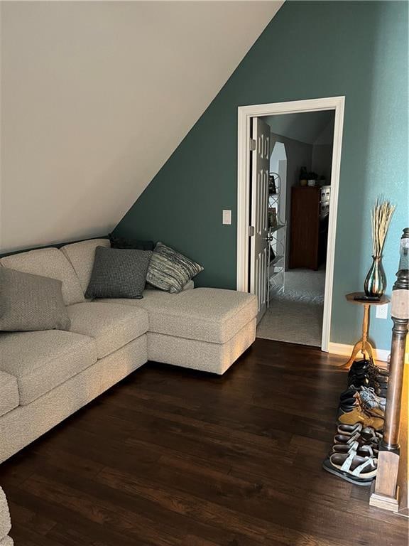 living room with hardwood / wood-style flooring and vaulted ceiling