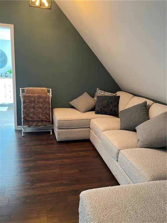 living room featuring sink, hardwood / wood-style flooring, and vaulted ceiling