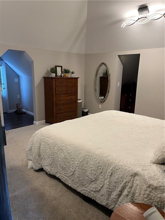 bedroom featuring lofted ceiling and carpet flooring