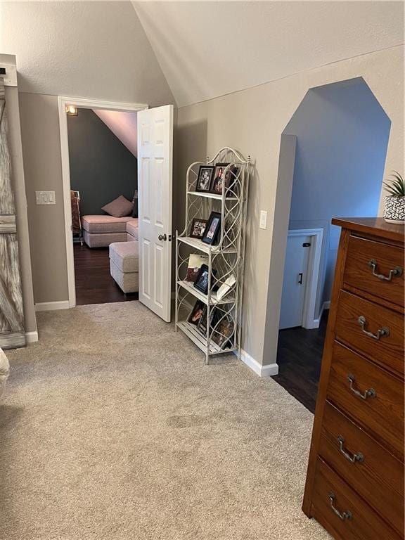 carpeted bedroom featuring lofted ceiling