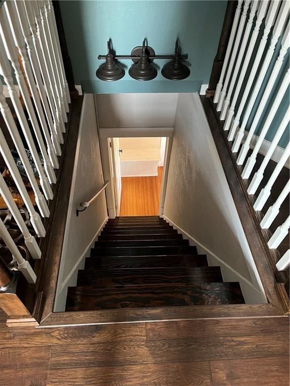 stairway with hardwood / wood-style floors