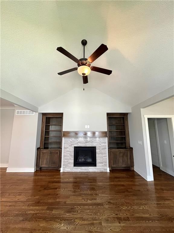 unfurnished living room featuring built in features, dark wood-type flooring, ceiling fan, and lofted ceiling