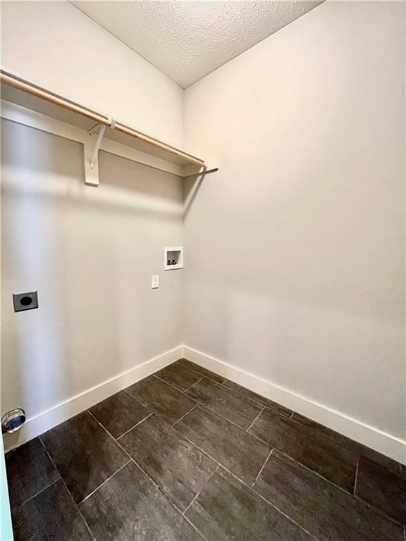 laundry room with hookup for an electric dryer, a textured ceiling, and washer hookup