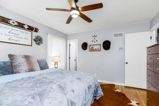 bedroom featuring hardwood / wood-style flooring and ceiling fan