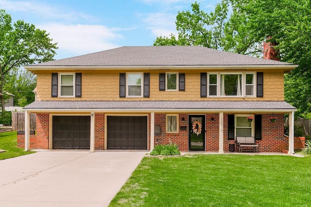 view of front of home featuring a front lawn, covered porch, and a garage